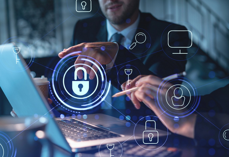 IT support tech setting up cybersecurity measures on business owners laptop.